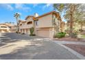 A townhouse exterior featuring private garages, balconies, and neatly trimmed landscaping at 2050 W Warm Springs Rd # 3322, Henderson, NV 89014
