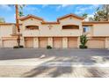 A row of townhouses with garages, balconies, and well-kept landscaping in front at 2050 W Warm Springs Rd # 3322, Henderson, NV 89014