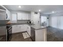 Bright kitchen with white cabinetry, granite countertops, stainless steel appliances, and modern finishes at 2681 Tuxedo Black Ct, North Las Vegas, NV 89086