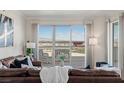 Bright living room with comfortable seating and access to a spacious balcony with city views at 2777 Paradise Rd # 1105, Las Vegas, NV 89109