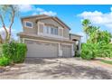 Two-story house with a three-car garage and landscaped yard at 2891 Painted Lilly Dr, Las Vegas, NV 89135