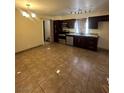 Functional kitchen featuring tile floors, modern appliances, and dark wood cabinets at 3551 Rio Mayo Dr, Las Vegas, NV 89121