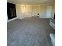 Spacious living room featuring neutral carpeting and plenty of natural light at 3551 Rio Mayo Dr, Las Vegas, NV 89121
