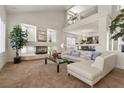 Bright living room with a cozy fireplace, modern decor, and an open floor plan at 4439 Melrose Abbey Pl, Las Vegas, NV 89141