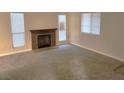 Living room with fireplace and neutral carpeting at 4708 Obannon Dr # C, Las Vegas, NV 89102
