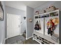 Inviting entryway features a storage bench with shoe rack, hooks, and shelves at 5940 Palmilla St # 9, North Las Vegas, NV 89031
