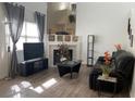 Living room with fireplace, hardwood floors and black leather couch at 6250 W Flamingo Rd # 88, Las Vegas, NV 89103