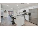 Modern kitchen with granite countertops, stainless steel appliances, and island at 6867 Evening Orchid St, North Las Vegas, NV 89086