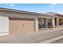 Exterior view of the home showcasing the attached garage and covered porch at 723 Orange Plume Walk # 0, Henderson, NV 89011