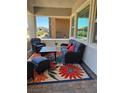 Relaxing covered porch featuring cozy seating, a vibrant rug, and natural light at 723 Orange Plume Walk # 0, Henderson, NV 89011