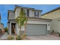 Two-story house with gray siding, gray garage door, and dark brown window shutters at 7675 W Mistral Ave, Las Vegas, NV 89113