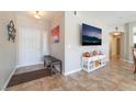 Inviting foyer featuring neutral colors, tile flooring, a bench and a stylish decor at 830 Cozette Ct # 102, Las Vegas, NV 89144