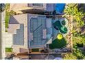 Expansive backyard oasis featuring a pool, spa, and lush landscaping, perfect for relaxation at 10654 Sidlaw Hills Ct, Las Vegas, NV 89141
