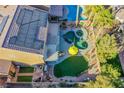 Lush backyard with a luxurious pool, spa, green space, and mature trees at 10654 Sidlaw Hills Ct, Las Vegas, NV 89141