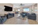 Spacious living room with tile floors, comfortable seating, and scenic views at 1802 Cypress Mesa Dr, Henderson, NV 89012