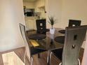 Small dining area with glass table and four black chairs at 200 N Bruce St # A, Las Vegas, NV 89101