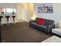 Cozy living room featuring a gray couch and an accent chair at 200 N Bruce St # A, Las Vegas, NV 89101