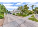 Spacious driveway with landscaping and two-car garage at 2049 Troon Dr, Henderson, NV 89074