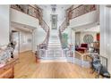 Grand two-story entry with curved staircase and hardwood floors at 2049 Troon Dr, Henderson, NV 89074