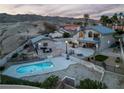 Aerial view showcases the backyard with a private pool and outdoor dining area, perfect for entertaining at 2327 River City Dr, Laughlin, NV 89029