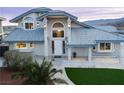 Charming home boasts a well-manicured lawn, tiled roof, and inviting entrance, enhancing its curb appeal at 2327 River City Dr, Laughlin, NV 89029