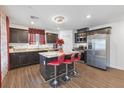 Modern kitchen with granite counters, dark cabinets, and stainless steel appliances at 3558 Herodain Ave, Las Vegas, NV 89106