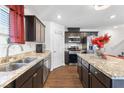 Stylish kitchen features granite countertops, stainless appliances, and dark cabinetry at 3558 Herodain Ave, Las Vegas, NV 89106