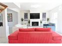 Bright living room features a fireplace with brick surround and contemporary furnishings at 4193 W Warm Springs Rd, Las Vegas, NV 89118