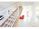 Bright staircase with white railing, wood stairs and wood beam at 4193 W Warm Springs Rd, Las Vegas, NV 89118