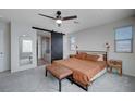 Calm and inviting main bedroom with a ceiling fan and barn door leading to the ensuite bathroom at 422 Barcarolle Ln, Henderson, NV 89011