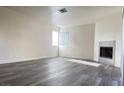 Spacious living room with gray vinyl flooring and a modern fireplace at 5002 S Rainbow Blvd # 106, Las Vegas, NV 89118