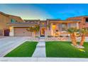 Two-story home with a three-car garage and landscaped yard at 61 Contrada Fiore Dr, Henderson, NV 89011