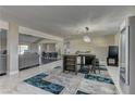 Open dining area with a modern table, stylish chairs, and seamless flow to the living space at 8880 W Ann Rd, Las Vegas, NV 89149