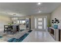 Inviting entryway with stylish tile flooring, modern light fixture, and sleek decor at 8880 W Ann Rd, Las Vegas, NV 89149