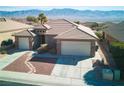 Well-maintained home featuring desert landscaping, a paver walkway, and a 2-car garage with mountain views at 1428 Chaparral Dr, Mesquite, NV 89027
