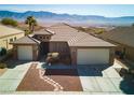 Well-maintained home featuring desert landscaping, a paver walkway, and a 2-car garage with mountain views at 1428 Chaparral Dr, Mesquite, NV 89027