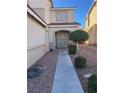 Inviting front entrance with a well-maintained walkway and beautiful landscaping at 1733 Gentle Brook St, North Las Vegas, NV 89084