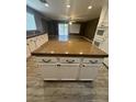 Beautiful kitchen island with granite countertops, white cabinetry, and stainless steel appliances at 1733 Gentle Brook St, North Las Vegas, NV 89084