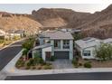 Aerial view of a modern, two-story home with desert landscaping in a community near the mountains at 1945 Canyon Highlands Dr, Henderson, NV 89052