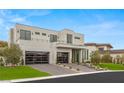 Contemporary two-story home with a landscaped yard, showcasing modern architectural design and an inviting entrance at 21 Grey Owl Ct, Las Vegas, NV 89135