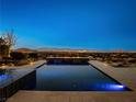 Resort-style pool with city views at night at 26 Olympia Outlook Dr, Las Vegas, NV 89141