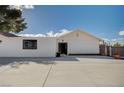 Side view of a newly painted home with a large concrete patio area at 2690 S Dandelion St, Pahrump, NV 89048