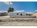 Newly renovated single story home with a large driveway and desert landscaping at 2690 S Dandelion St, Pahrump, NV 89048