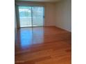 Bright living room featuring wood floors, large sliding glass door, and natural light at 3055 Key Largo Dr # 203, Las Vegas, NV 89120