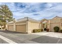 Tan stucco house with two-car garage and landscaping at 448 Wonderstone Dr, Las Vegas, NV 89107