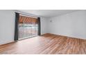 Bright living room with hardwood floors and large window at 4554 S Nellis Blvd, Las Vegas, NV 89121