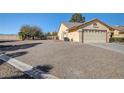 Single-story home with a two-car garage and a gravel driveway at 5105 Kingsbridge Dr, Las Vegas, NV 89130