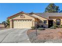Charming single-story home featuring a two-car garage and a well-maintained desert landscape at 5105 Kingsbridge Dr, Las Vegas, NV 89130