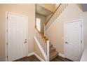 Inviting stairway with carpeted steps and white railing connecting the home's levels at 8063 Sundance Valley Dr, Las Vegas, NV 89178