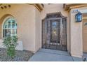 Ornate wrought-iron gate leading to the front entry of the home at 8109 Mountain Forest Ct, Las Vegas, NV 89129